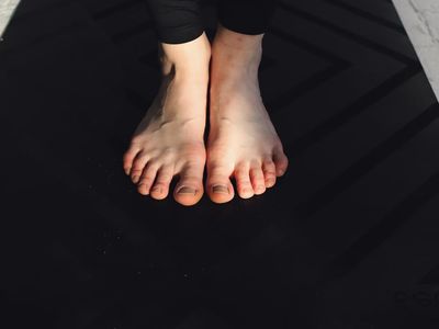 Close-up of feet on a yoga mat.